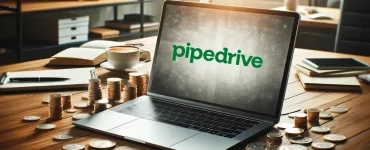 a laptop surrounded by money with the pipedrive crm logo displayed