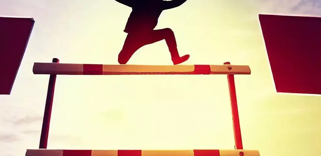person overcoming hurdles and objections to gain success