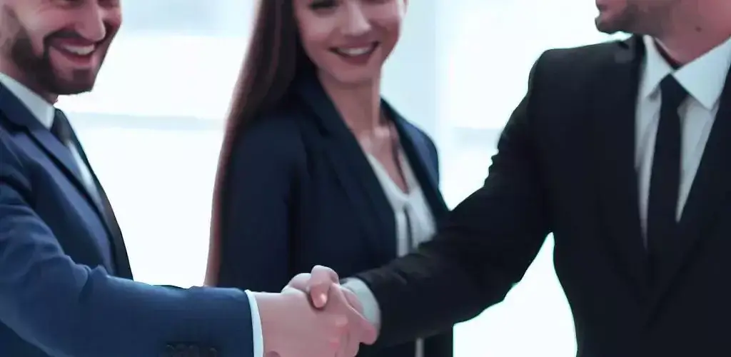 a sales team shaking hands with a customer