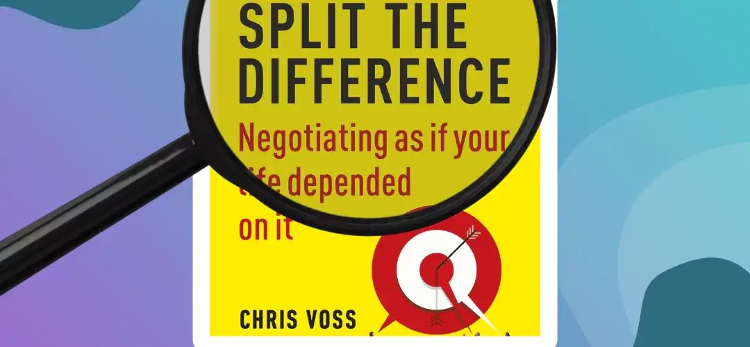 a magnifying glass overt the top of popular sales tactics book "Never Split the Difference" by chris voss